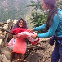 Pasang distributes tarps and blankets to elderly people in Laprak, Nepal